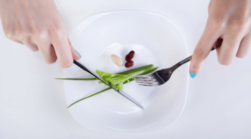 woman with tiny food portions featured