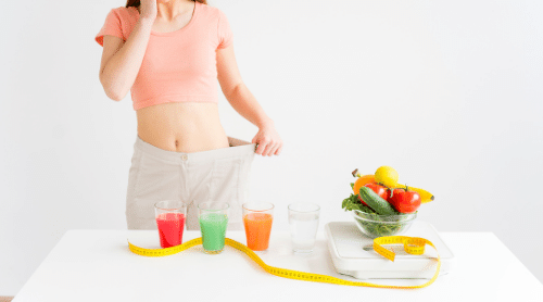 thin woman with veggies, scale, measuring tape and veggie juice featured