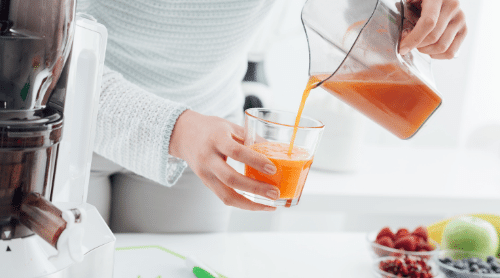 pouring fresh juice into glass featured