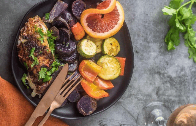 Mexican roasted chicken and veggies on dark plate