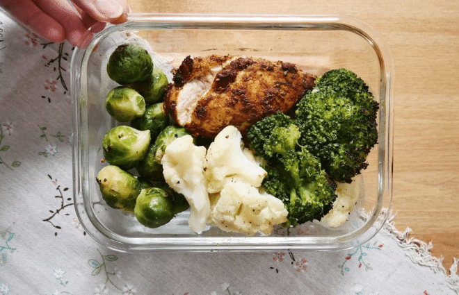 spicy curried chicken meal prep in glass storage container